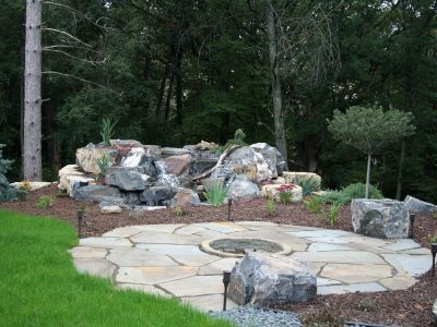 St. Croix Valley,  WI - New  York Bluestone Patio with Firepit next to Pondless Waterfall